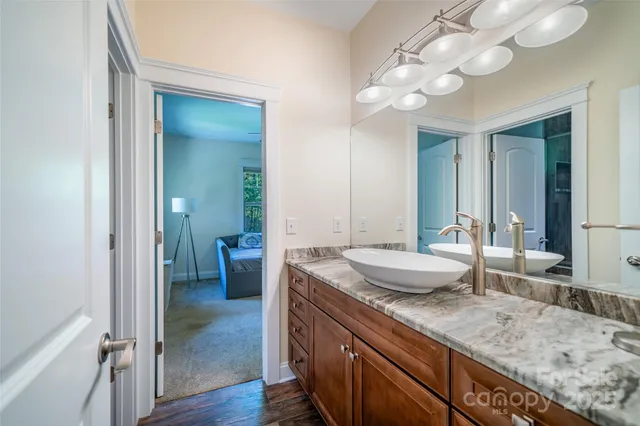 a bathroom with a toilet a sink and a mirror