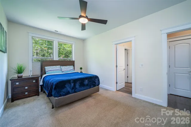 an aerial view of residential house with outdoor space and trees all around