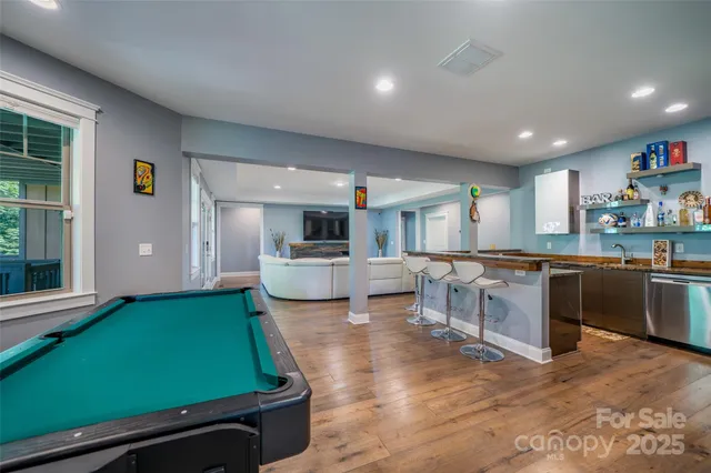 a kitchen with a sink cabinets and wooden floor