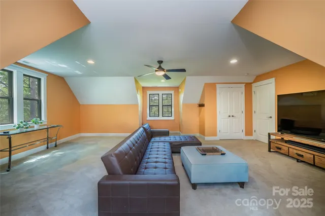 a view of a patio with table and chairs potted plants with large tree