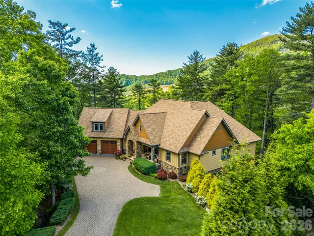 a view of a dining room with furniture a chandelier and wooden floor