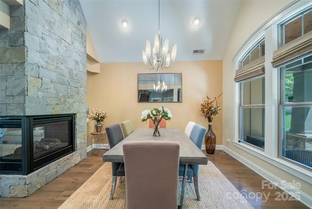 a view of a dining room with furniture a chandelier and wooden floor