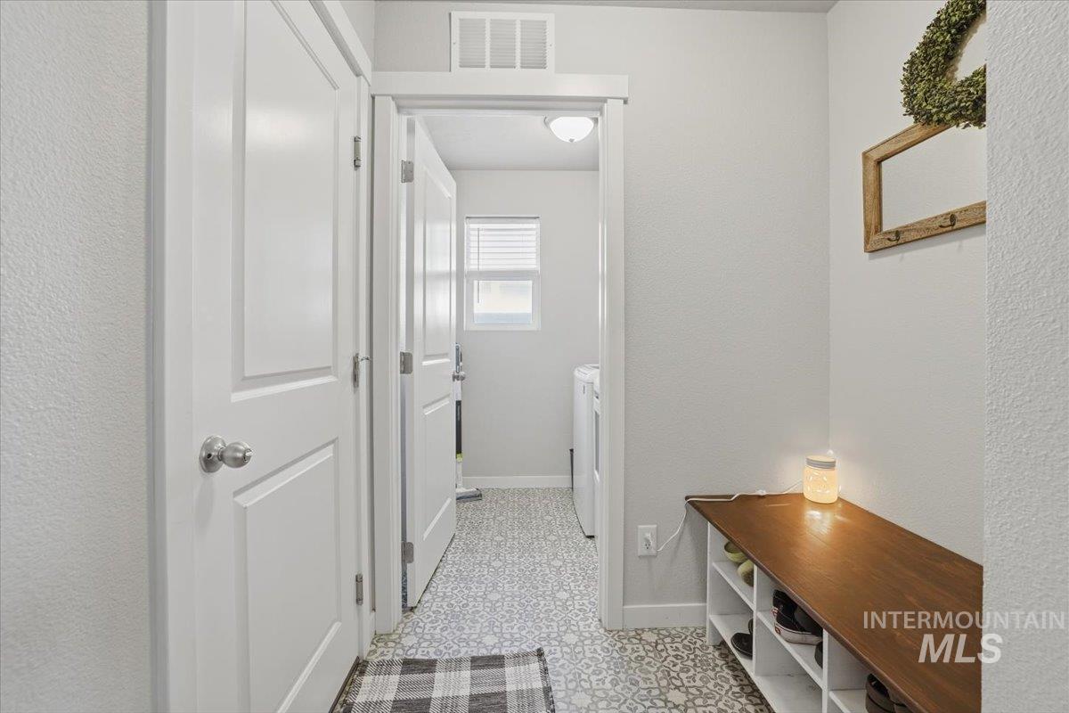 16682 Loggia Avenue Caldwell, ID 83607 - Photo 19 of 46 Mudroom with a textured wall and washing machine and clothes dryer