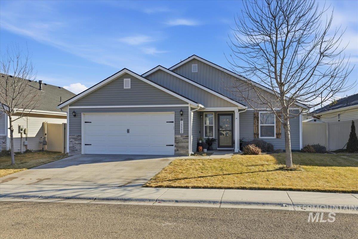 16682 Loggia Avenue Caldwell, ID 83607 - Photo 2 of 46 Single story home featuring concrete driveway, stone siding, an attached garage, and board and batten siding