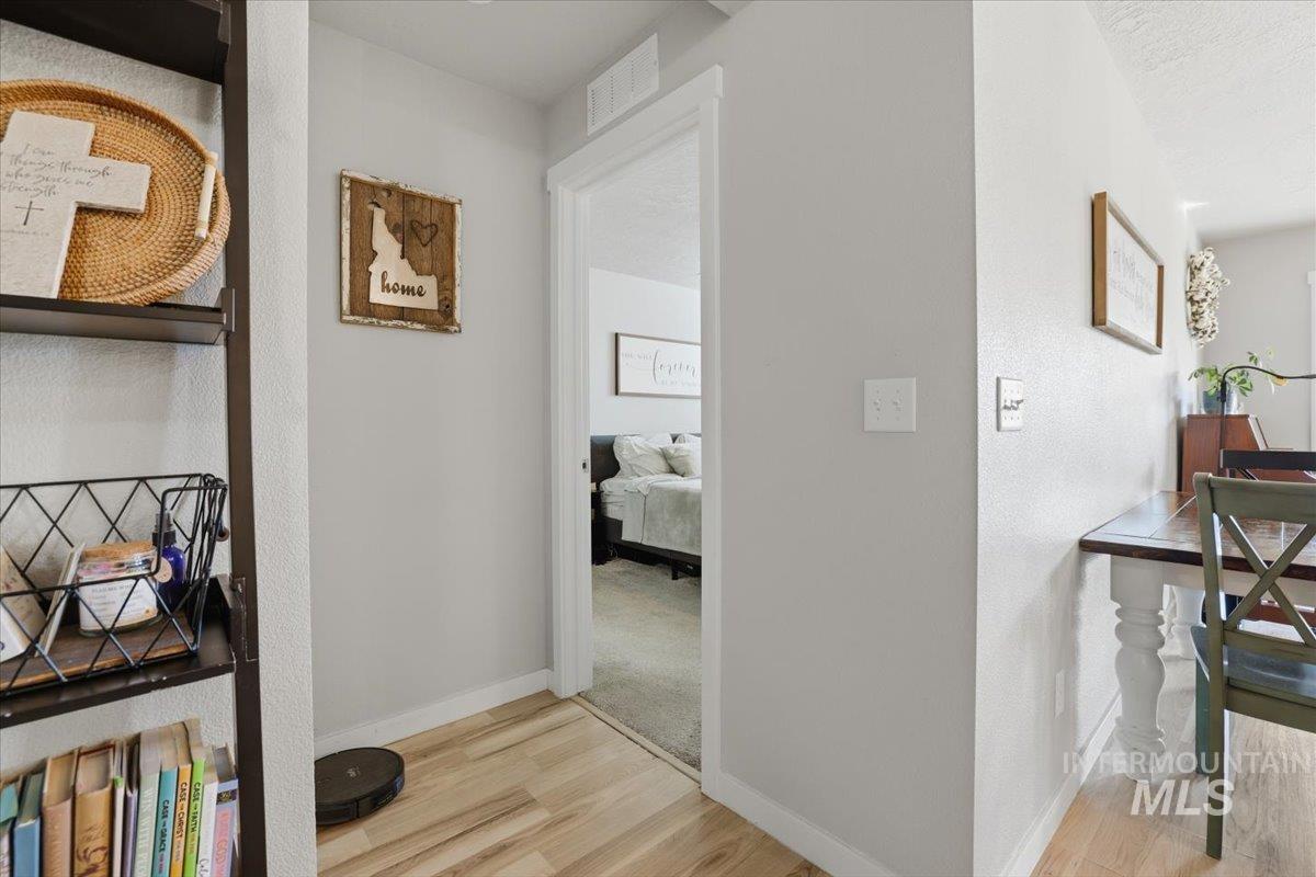16682 Loggia Avenue Caldwell, ID 83607 - Photo 22 of 46 Corridor featuring light wood-style flooring and baseboards