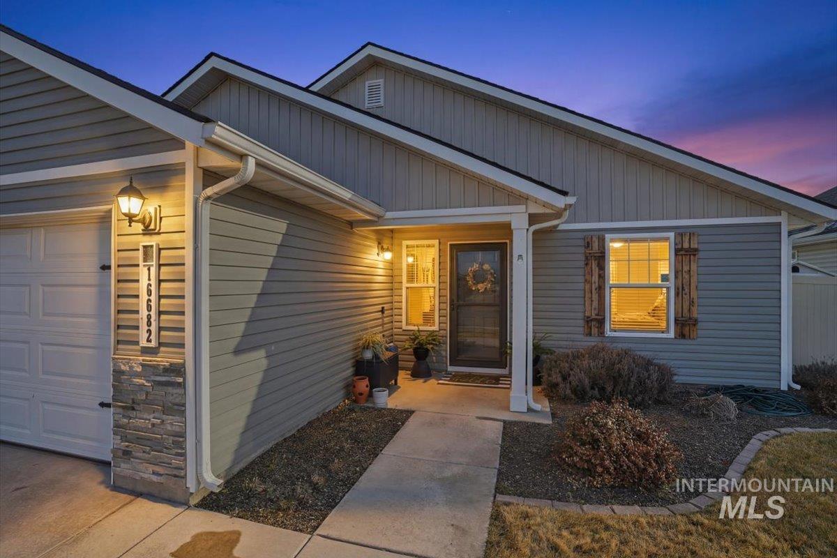 16682 Loggia Avenue Caldwell, ID 83607 - Photo 3 of 46 View of exterior entry featuring a garage and stone siding
