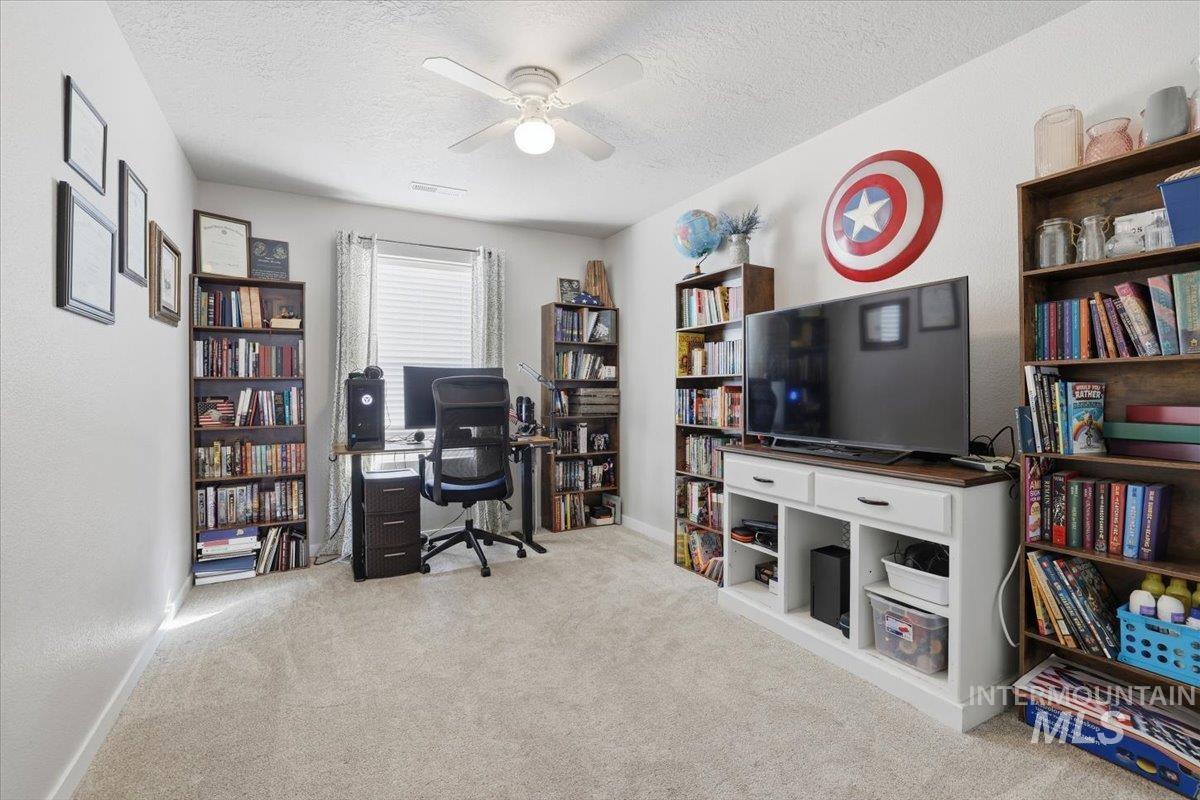 16682 Loggia Avenue Caldwell, ID 83607 - Photo 39 of 46 Office area featuring ceiling fan, light colored carpet, and a textured ceiling