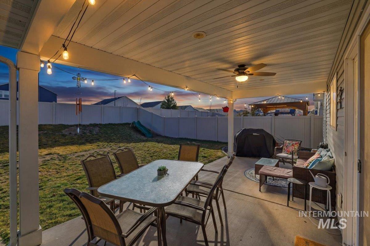 16682 Loggia Avenue Caldwell, ID 83607 - Photo 42 of 46 Fenced backyard with outdoor dining space, a patio area, a grill, and ceiling fan