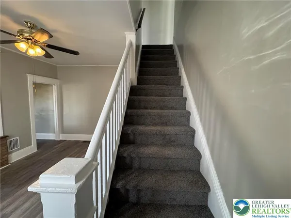 a view of entryway and hall with wooden floor