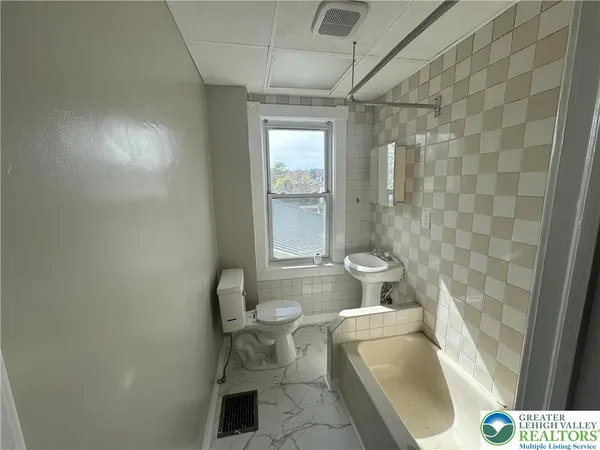 a bathroom with a toilet and a sink