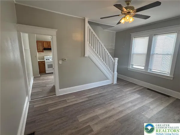 wooden floor in an empty room with a window