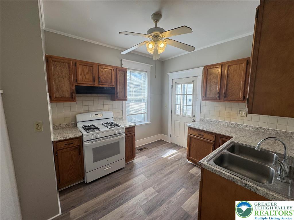 113 East Madison Street Easton, PA 18042 - Photo 7 of 15 a kitchen with stainless steel appliances granite countertop a stove and a sink