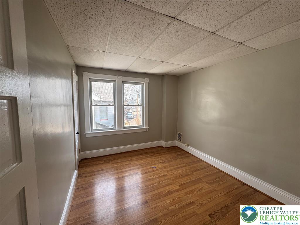 113 East Madison Street Easton, PA 18042 - Photo 8 of 15 an empty room with wooden floor and windows