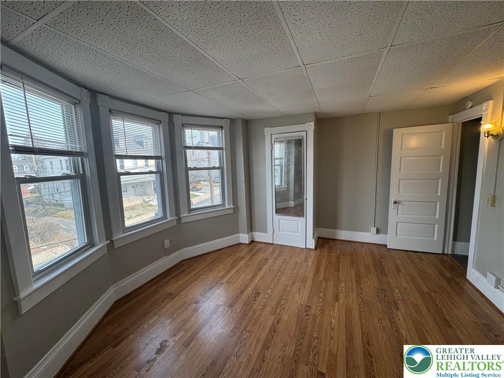 113 East Madison Street Easton, PA 18042 - Photo 10 of 15 a view of an empty room with wooden floor and a window
