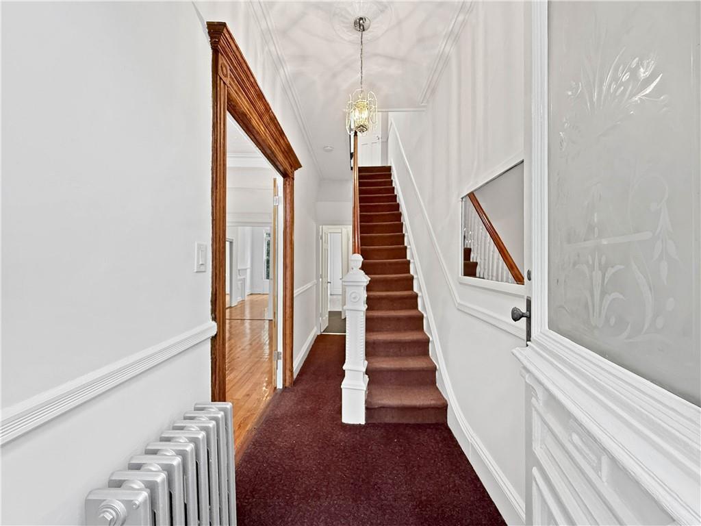 13 Windsor Place Brooklyn, NY 11215 - Photo 12 of 40 a view of staircase with lots of frames on wall and wooden floor