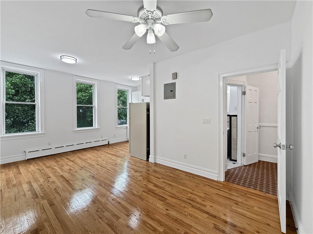 13 Windsor Place Brooklyn, NY 11215 - Photo 28 of 40 wooden floor in an empty room with a window