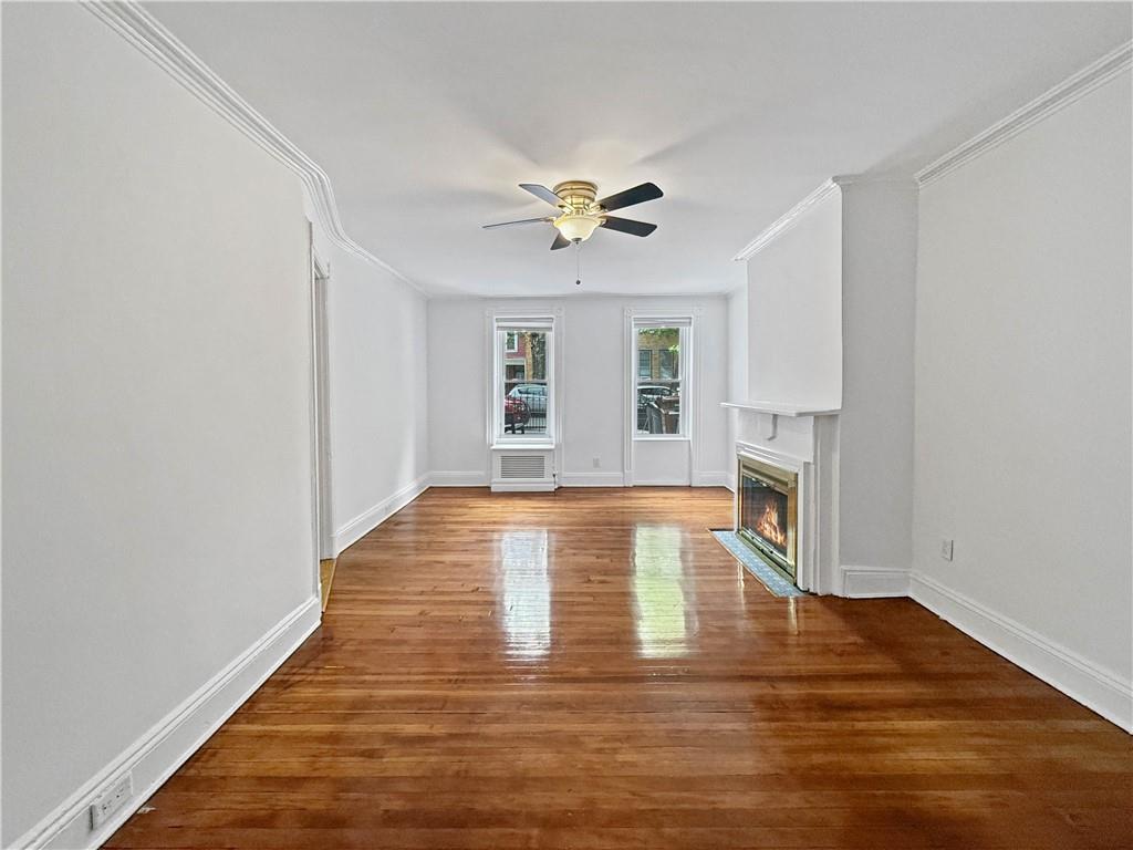 13 Windsor Place Brooklyn, NY 11215 - Photo 4 of 40 a view of empty room with wooden floor and fan