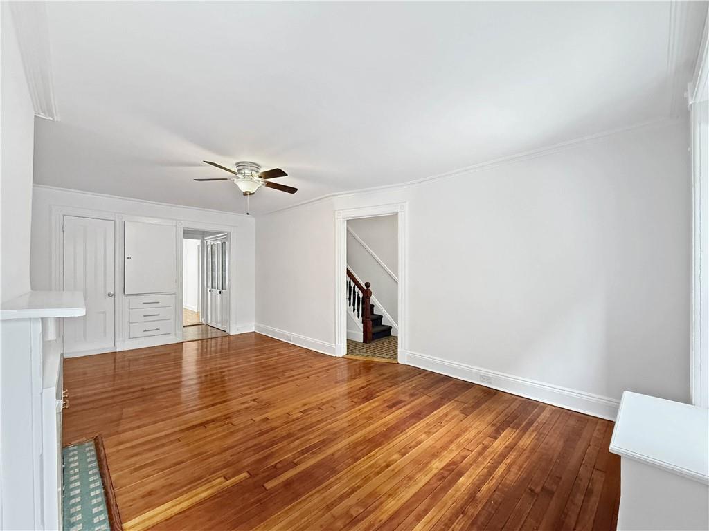 13 Windsor Place Brooklyn, NY 11215 - Photo 6 of 40 a view of empty room with wooden floor and fan