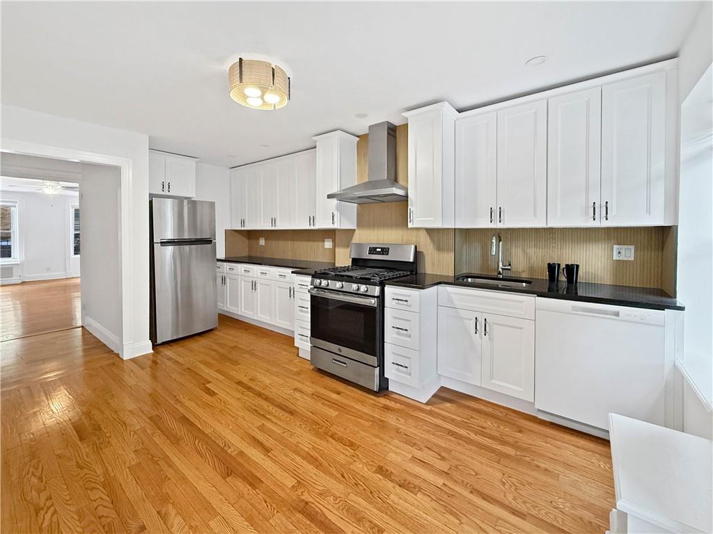13 Windsor Place Brooklyn, NY 11215 - Photo 9 of 40 a kitchen with granite countertop white cabinets and stainless steel appliances