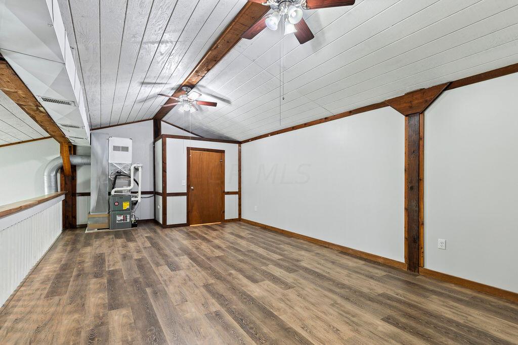 10389 Center Village Road, Unit A Galena, OH 43021 - Photo 23 of 39 view from top of the stairs showing loft with walk in closet/used as primary bedroom
