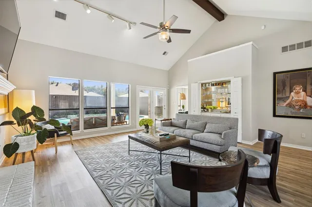 a living room with furniture or couch and a large window
