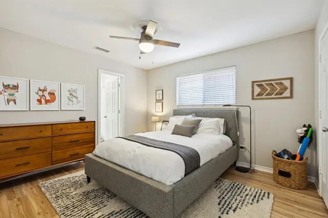 a bedroom with a bed and wooden floor