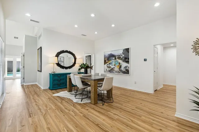 a view of a dining room with furniture and a mirror