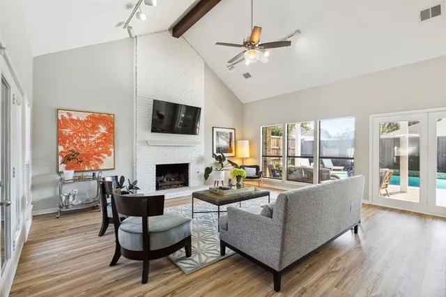 a living room with furniture a flat screen tv and a fireplace