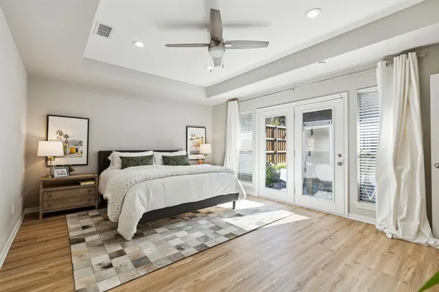 a bedroom with a large bed a chandelier and closet