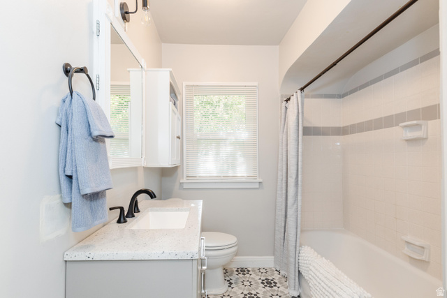 227 West 200 North Logan, UT 84321 - Photo 21 of 44 Bathroom featuring a vanity with a speckled countertop, undermount sink, matte black faucet, and patterned floor tile