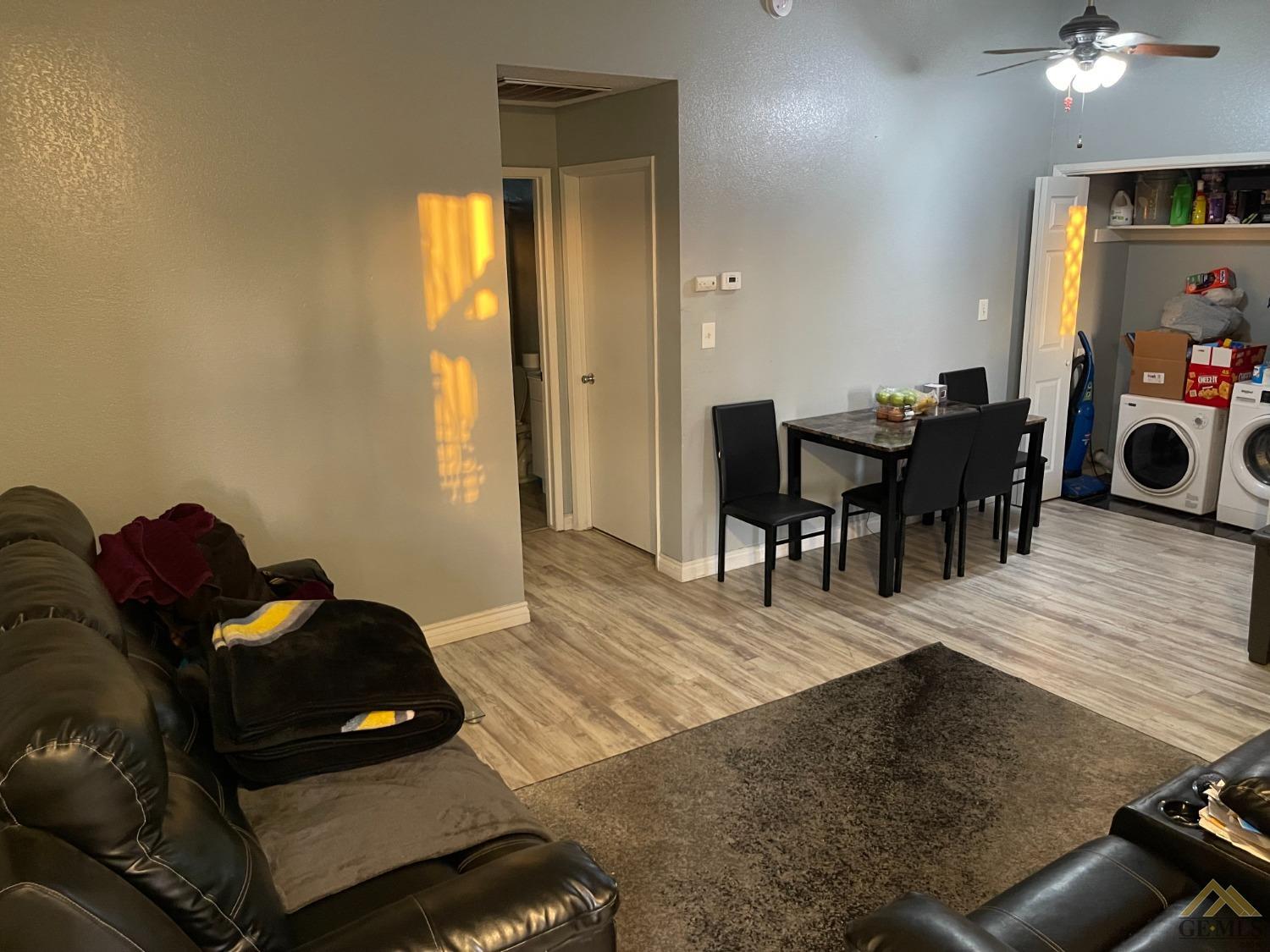 Undisclosed Address Bakersfield, CA 93309 - Photo 2 of 11 a living room with furniture and a wooden floor