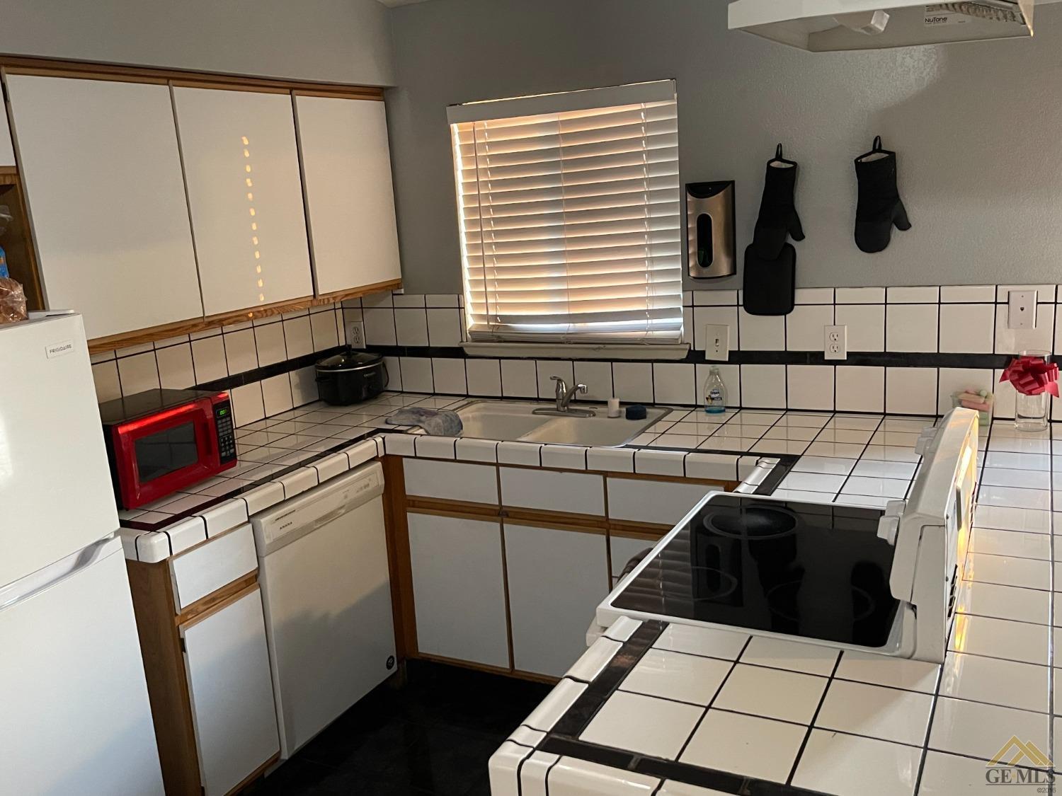 Undisclosed Address Bakersfield, CA 93309 - Photo 4 of 11 a kitchen with a sink and a stove top oven