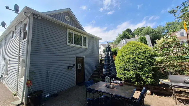 a backyard of a house with table and chairs
