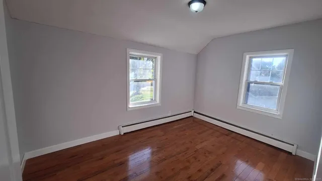 an empty room with windows and closet