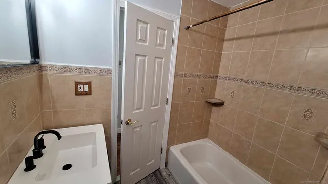 a view of a storage & utility room with a sink