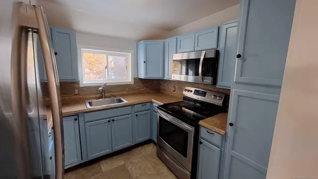 a kitchen with a sink stove and microwave