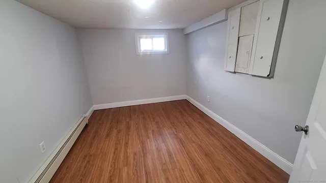 a view of a room with wooden floor and windows