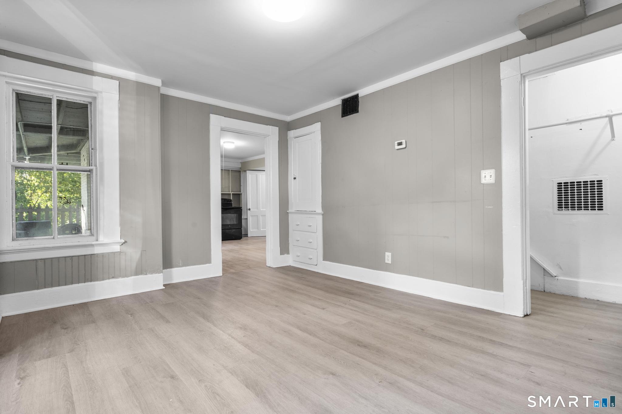 18 Hobart Street Meriden, CT 06450 - Photo 15 of 16 a view of an empty room with wooden floor and a window