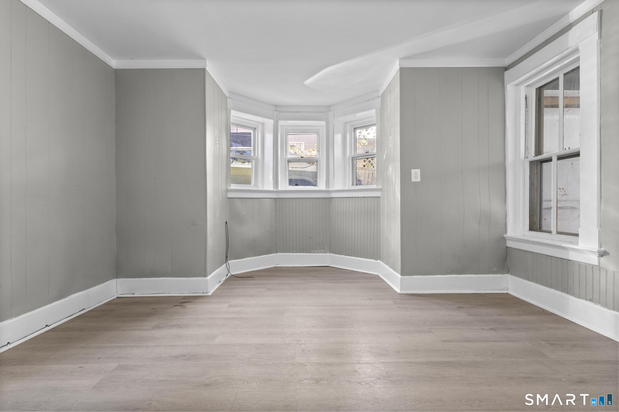 18 Hobart Street Meriden, CT 06450 - Photo 16 of 16 a view of an empty room with wooden floor and a window