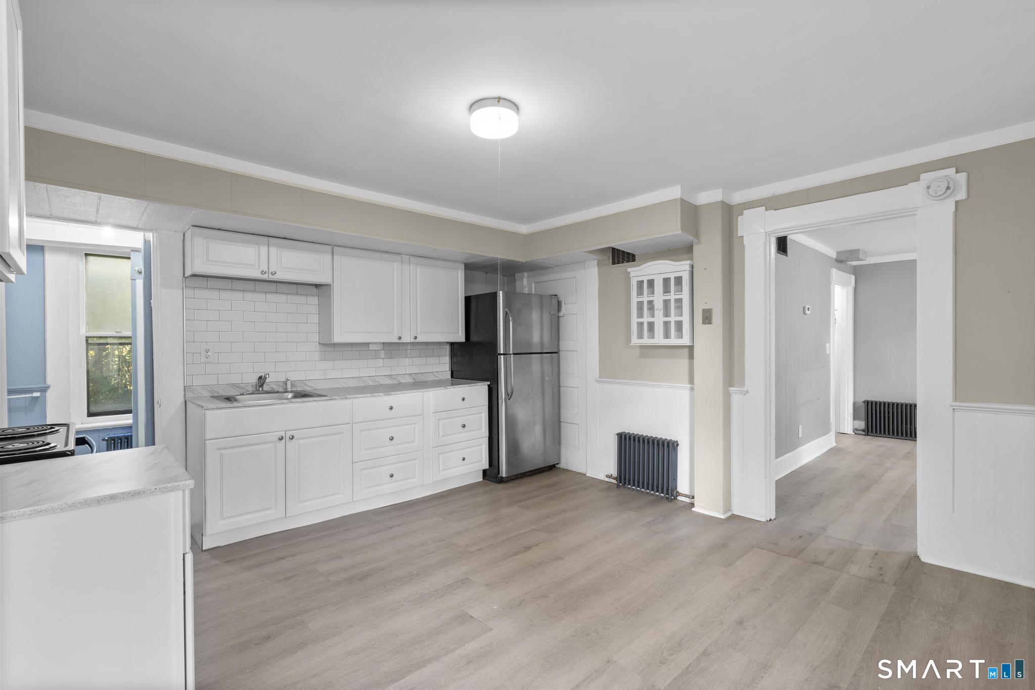 18 Hobart Street Meriden, CT 06450 - Photo 2 of 16 a kitchen with a refrigerator and white cabinets