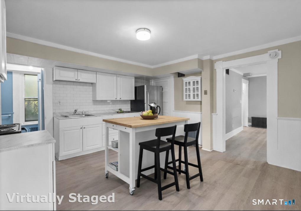 18 Hobart Street Meriden, CT 06450 - Photo 3 of 16 a kitchen with a sink cabinets and wooden floor