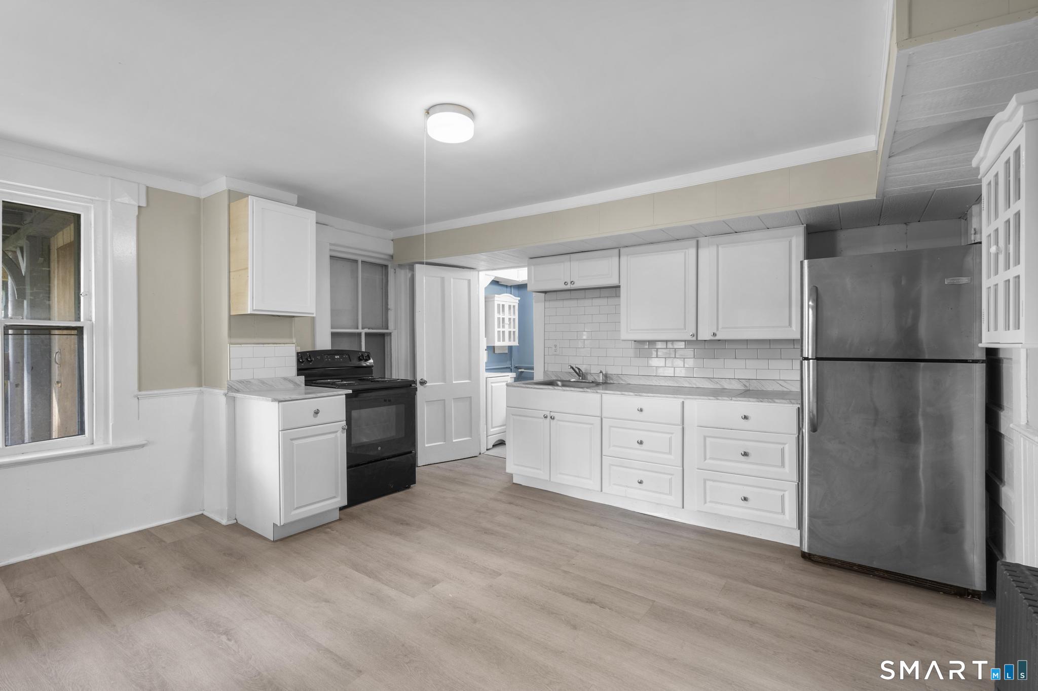 18 Hobart Street Meriden, CT 06450 - Photo 5 of 16 a kitchen with granite countertop white cabinets and stainless steel appliances