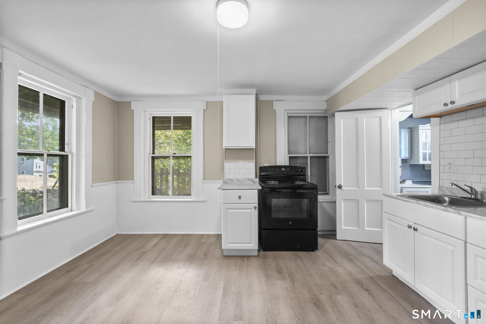 18 Hobart Street Meriden, CT 06450 - Photo 6 of 16 a kitchen with a refrigerator and a stove top oven