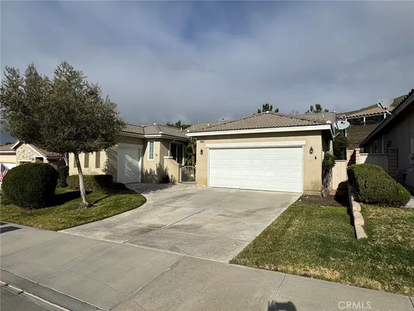a view of a house with a yard and garage