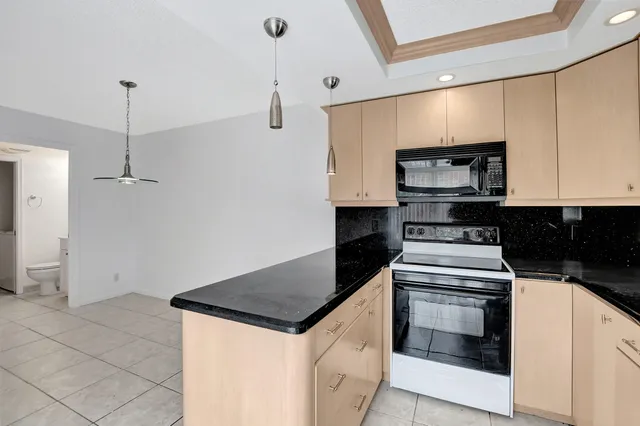 a kitchen with a sink and stainless steel appliances