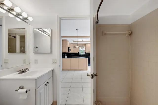 a bathroom with a sink a mirror and shower