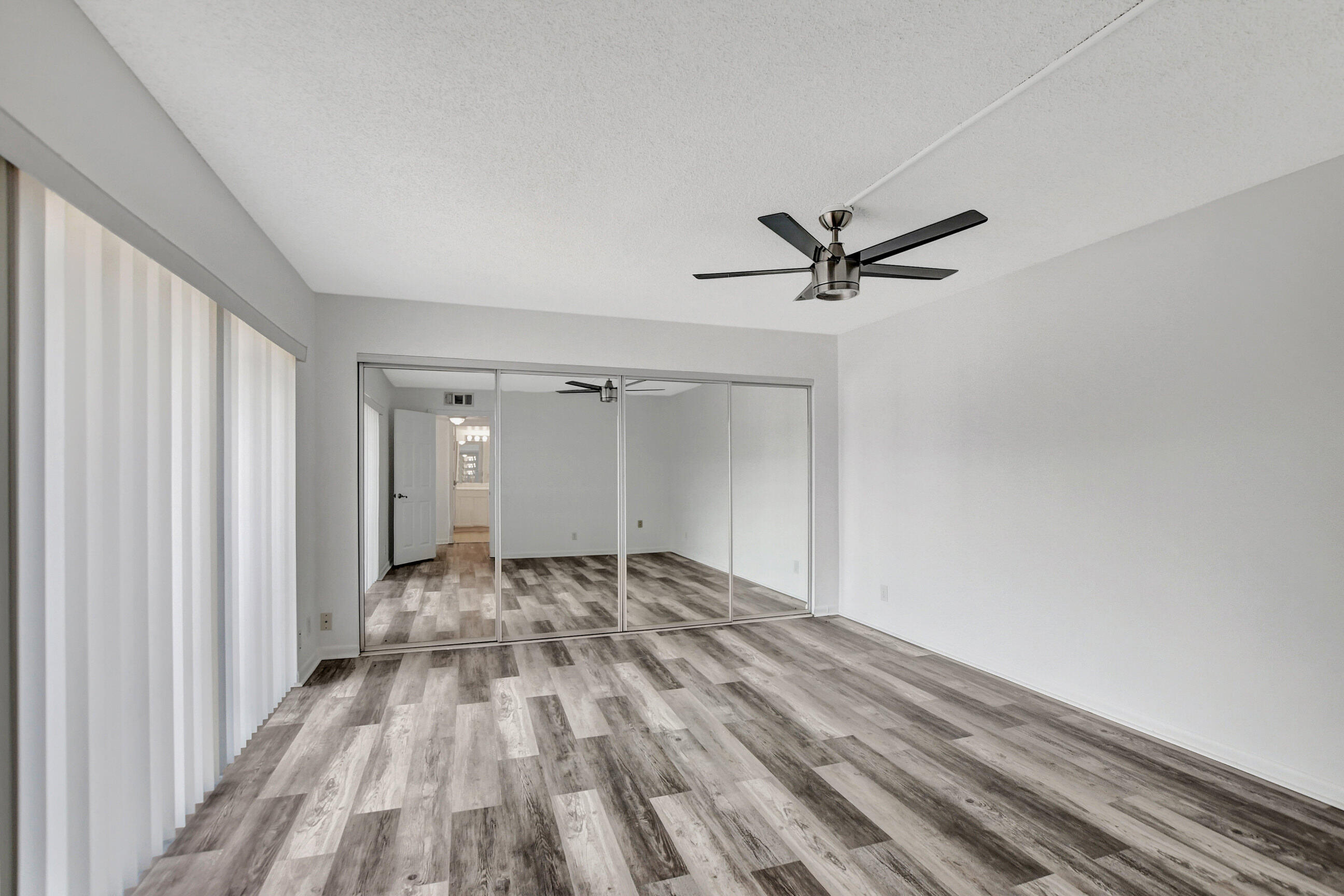 2555 Albatross Road North, Unit 2A Delray Beach, FL 33444 - Photo 20 of 27 a view of a livingroom with a ceiling fan and wooden floor