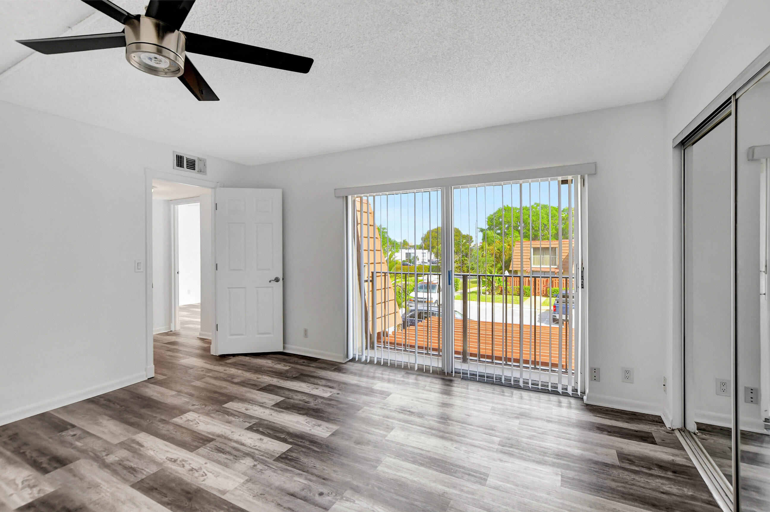 2555 Albatross Road North, Unit 2A Delray Beach, FL 33444 - Photo 22 of 27 wooden floor in an empty room with a window
