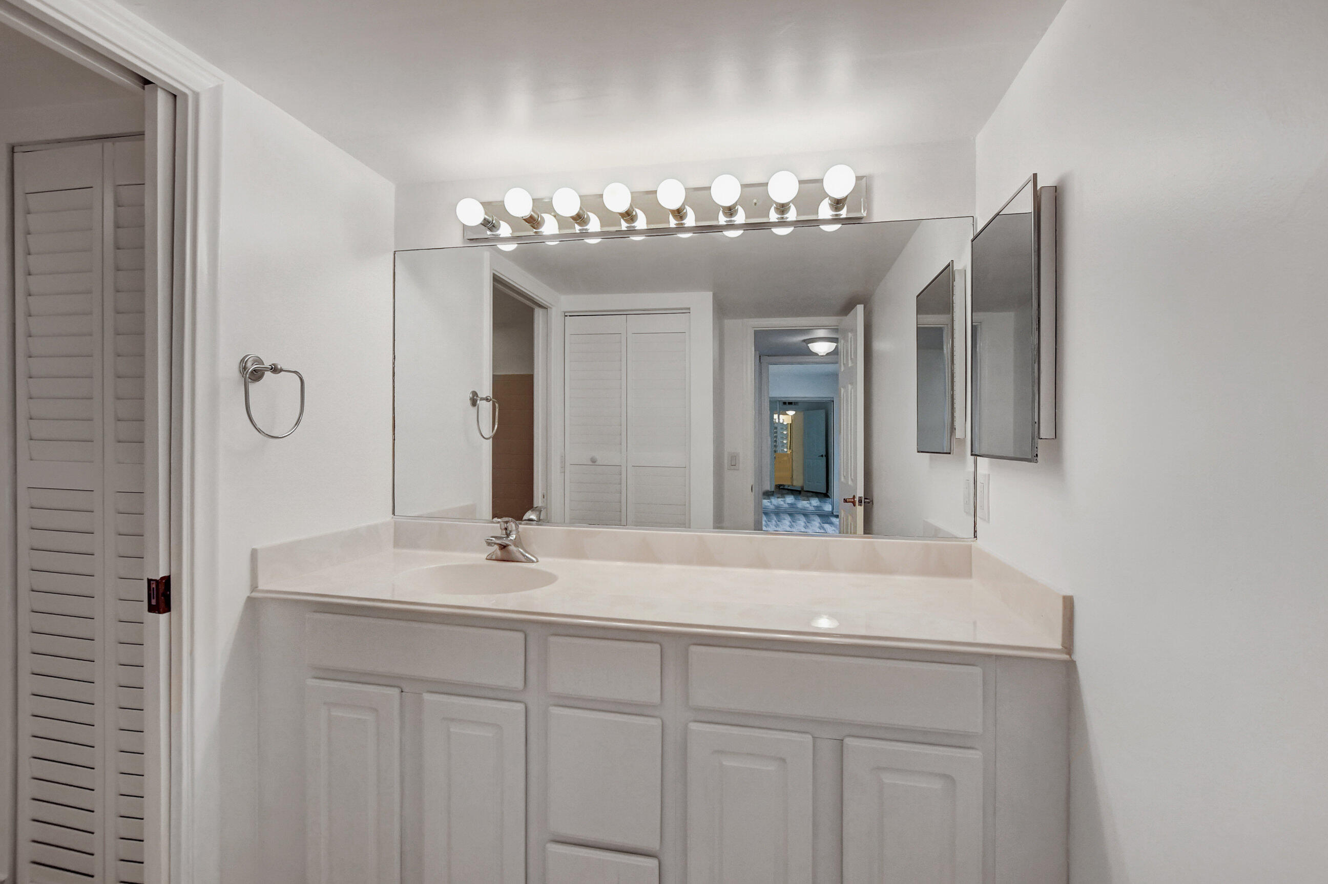 2555 Albatross Road North, Unit 2A Delray Beach, FL 33444 - Photo 23 of 27 a bathroom with a sink and a mirror