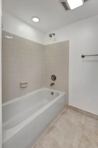 a spacious bathroom with a bathtub and a shower